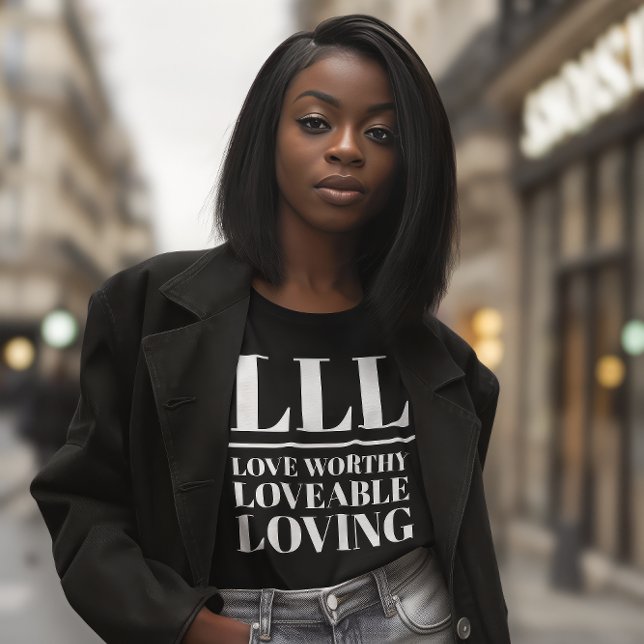 LLL-Kärlek Worthy, Loveable, Loving T Shirt (Young African American woman wears a black shirt that reads "LLL: Love Worthy, Loveable, Loving.")