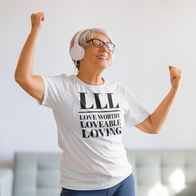 LLL-Kärlek Worthy, Loveable, Loving T Shirt (Older woman dances in a "LLL: Love Worthy, Loveable, Loving" white t-shirt.)