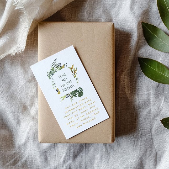 Löv och blomkrans, blommigt gräns tilläggskort (Botanical thank-you card with watercolor green leaves on white, placed on a kraft-wrapped gift)