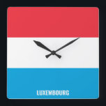 Luxemburgs Flagga Patriotic Fyrkantig Klocka<br><div class="desc">Den luxemburgska Flagga Patriotic Square Wall Clock med flagga land i färg tryckt hela tiden. Land namn är delvis integrerat i utformningen på grund. Anpassadet Text är fullt ut med funktionen "Anpassa den!". Den här charmerande utformningen är den häpnadsväckande presenten och den underbara show biet på väggen. © LänderAvVärlden</div>