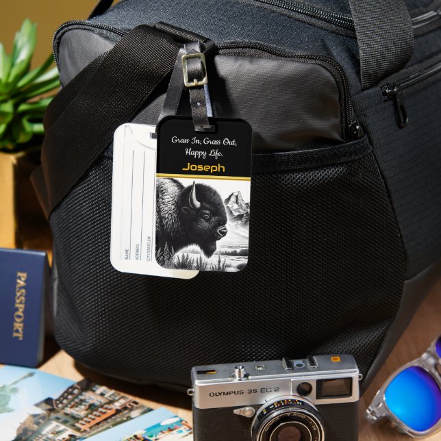 Majestic Buffalo Grazing Near Ruged Mountain Bagagebricka (Framsida & Baksida)