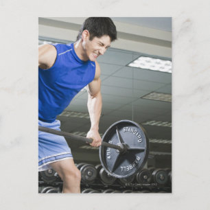 Man på gym, lyft stor barbell, klenande vykort