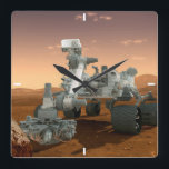Mars Science Laboratory Curiosity Rover. 4 Fyrkantig Klocka<br><div class="desc">Artists idé om mars Science Laboratory Curiosity Rover, en mobil robot för att undersöka Mars tidigare eller nuvarande förmåga att upprätthålla mikrobiellt liv. I bild utreder roven ett sten på Mars med en uppsättning verktyg i slutet av rovens arm, som sträcker sig omkring 7 fot. Två instrument vid arm kan...</div>