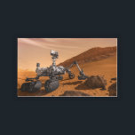 Mars Science Laboratory Curiosity Rover. Bricka<br><div class="desc">Artist concept of Mars Science Laboratory Curiosity rover, a mobile robot for investigating Mars' past or present ability to sustain microbial life. In this picture, the rover examines a rock on Mars with a set of tools at the end of the rover's arm, which extends about 7 feet. Two instruments...</div>