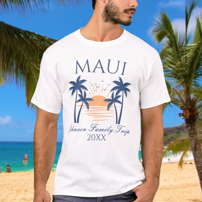 Maui Family Vacation Resa T-Shirt (Man wearing a Maui family trip t-shirt with a sunset and palm tree design, standing on a beach.)