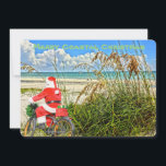 Merry Coastal jul Sanibel Island Beach Santa Julkort<br><div class="desc">God Kustjul! Det här fantastiska helgdag Flat Card har en bild av den sensationella Sanibel-ökstranden med sina torkande havre och den vackra blå/grönt vattenen Bukt i Mexiko. Den festliga designen omfattar tomten som kör sin cykel för att leverera paket på denna öoas. På julkortets baksida står det: "Varm önskemål för...</div>