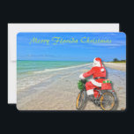 Merry Florida jul Sanibel Island Beach Santa Julkort<br><div class="desc">God Florida-jul! Det här fantastiska helgdag Flat Card har en bild av den sensationella Sanibel Island-stranden med det vackra vattenen blått/grönt i Mexikos Bukt. Den festliga designen omfattar tomten som kör sin cykel för att leverera paket på denna öoas. På julkortets baksida står det: "Varm önskemål för ett underbart helgdag...</div>
