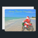 Merry Florida jul Sanibel Island Beach Santa Julkort<br><div class="desc">God Florida-jul! Det här fantastiska helgdag Flat Card har en bild av den sensationella Sanibel Island-stranden med det vackra vattenen blått/grönt i Mexikos Bukt. Den festliga designen omfattar tomten som kör sin cykel för att leverera paket på denna öoas. På julkortets baksida står det: "Varm önskemål för ett underbart helgdag...</div>