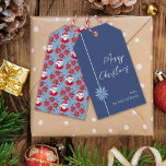 Minimal Poinsettia Blue Santa God jul Presentetikett<br><div class="desc">Den här enkla och minimala designen har min blåa poinsettia i hand plockade på mörk blått bakgrund på framsidan och en Santa och en traditionell röd poinsettia mönster på baksidan för en klassisk vibe som frammanar nostalgien från julen medan det illustrerade inslag och typsnittet ge en aning om stollig.</div>
