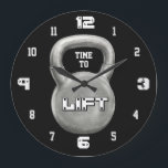 Minimalist Fitness Motivation Stor Klocka<br><div class="desc">This bold Time to Lift wall clock features a powerful kettlebell design on a sleek black background, creating a strong and modern gym aesthetic. The minimalist style makes it a perfect addition to any home gym, workout room, or fitness studio. The large kettlebell centerpiece with the motivational phrase “Time to...</div>