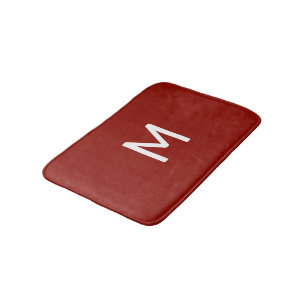 Minimalistiskt vitt monogram på rött badrumsmatta