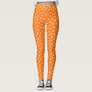 Mjuka persikofärgade blommor på orange bakgrund leggings