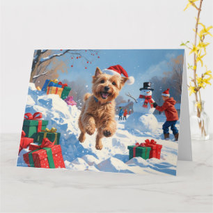 Mjukhårig Wheaten Terrier springer i snö med julha Kort