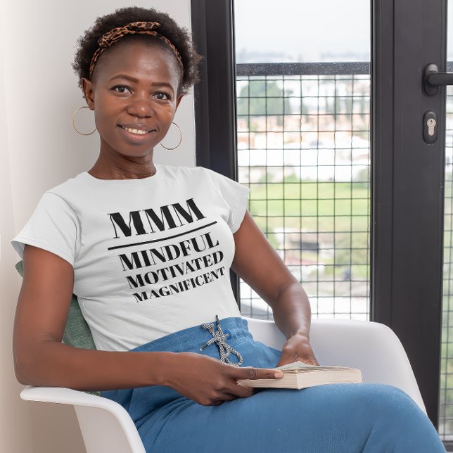 MMM- minutiös, motiverad, magnifik T Shirt (Young black woman wearing a "MMM:Mindful, Motivated, Magnificient" white t-shirt.)