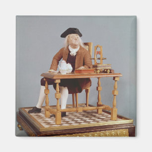 Modellera av Benjamin Franklin på hans bord Magnet