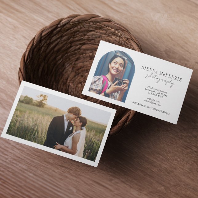 Modern Arch Script Photography Professionell Visitkort (Two business cards in a woven basket on a wooden table. One card shows a smiling woman with a camera)