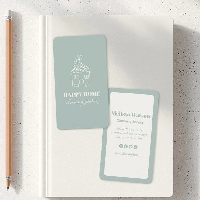 Modern Cute Snyggt House Städning Service Maid Visitkort (Two business cards on a white notebook. One card has a house sketch with Happy Home Cleaning Service)