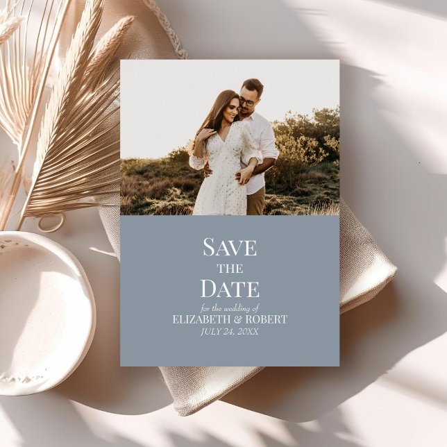 Modern Dusty Blue Anpassningsbar Photo Save Date C Inbjudningar (Modern Dusty Blue Custom Photo Save the Date Card on a neutral boho table with dry palm leaf.)