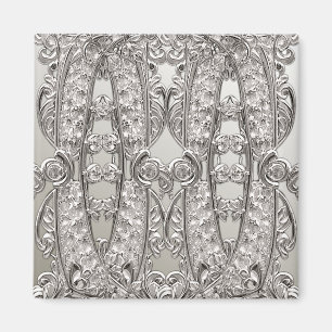 Modern magnet i silver med utsirad ornamentik