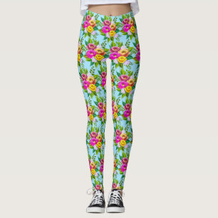 Moderna mångfärgade blommor på ljust blått leggings