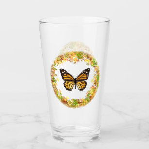 Monarch-fjäril i ram i löv glaskopp