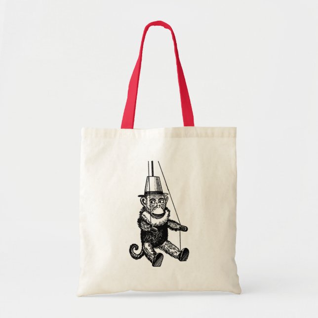 Monkey på en sträng mot en bag tygkasse (Framsidan)