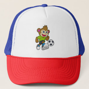 Monkey som fotbollsspelare med fotboll keps