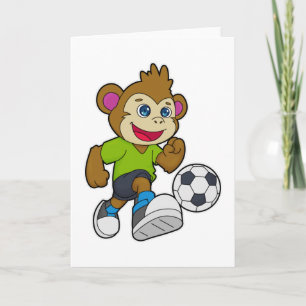 Monkey som fotbollsspelare med fotboll kort