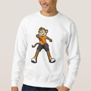 Monkey som tennis-spelare med tennis racket lång ärmad tröja