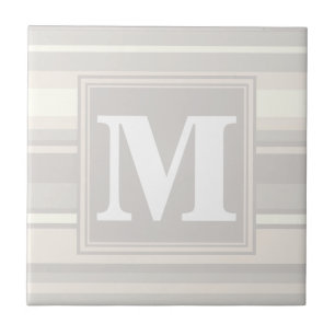 Monogram beige rand kakelplatta