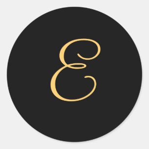 Monogram E, guld färgad initial E på svart. Runt Klistermärke