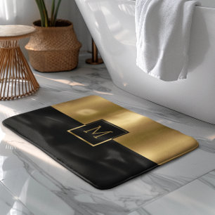 Monogram för geodesign i guld och svart badrumsmatta
