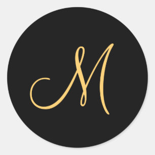 Monogram , guld färgad initial M på svart. Runt Klistermärke