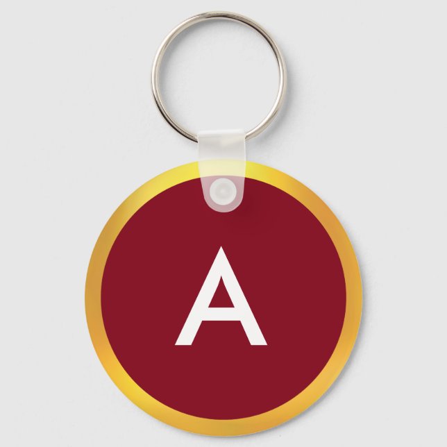 Monogram med gyllene cirkel på vit och krimsonröd nyckelring (Framsida)