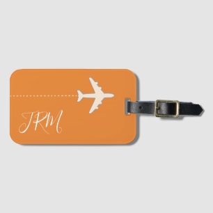 monogram och flygplan vid orange bagagebricka