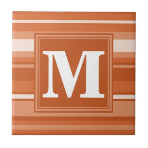 Monogram orange rand kakelplatta