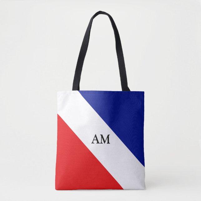 Monogram på blå, röd och vit diagonalt randig tygkasse (Framsida)