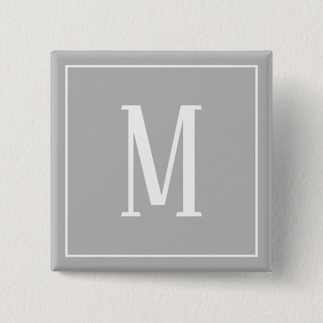 Monogram vit på grå fyrkantig knapp (Framsida)