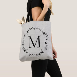 Monogrammerad krans med linens bakgrund tygkasse