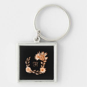 Monogrammerad svart brun och persikofärgad blommig fyrkantig silverfärgad nyckelring