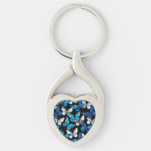 Mörk Sömlöst Mönster med Blue Butterflies Morpho Twisted Heart Silverfärgad Nyckelring