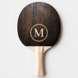 Mörk stenhackblock med monogram pingisracket