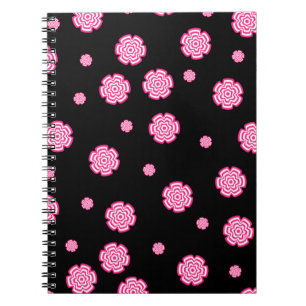 Mörkens bakgrundsljusa stiliserade rosa blommor. a anteckningsbok