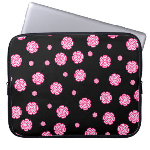 Mörkens bakgrundsljusa stiliserade rosa blommor. a laptop fodral