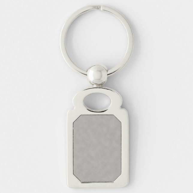 Mörkgrå pergamentstruktur bakgrund rektangulärt silverfärgad nyckelring (Framsidan)