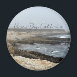 Morro Bay California Coastal Photography Magnet<br><div class="desc">A foggy overcast day in Morro Bay California with the ocean waves hitting the rocks on the shore in this beach photograph souvenir. This seaside travel photo keepsake magnet features black cursive script above the beach rocks and grey sky.</div>