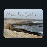 Morro Bay California Ocean Cliffs Photography Magnet<br><div class="desc">A foggy overcast day in Morro Bay California with the ocean waves hitting the rocks on the shore in this beach photograph souvenir. This seaside travel photo keepsake magnet gift features black cursive script above the beach rocks and grey sky.</div>