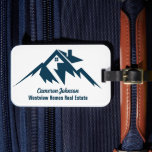 Mountain Real Estate Company Personalized Realtor Bagagebricka<br><div class="desc">A cool mountain range real estate company luggage tag for a realty business located in a mountainous city or town. The realtor name is written in navy blue script under the house among mountains. Great marketing item for a mountaintop home builder.</div>
