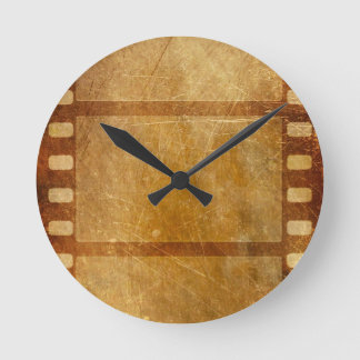MOVIE REEL OLD-FASHIONED GRUNGE GULD BACKGROUND DI RUND KLOCKA