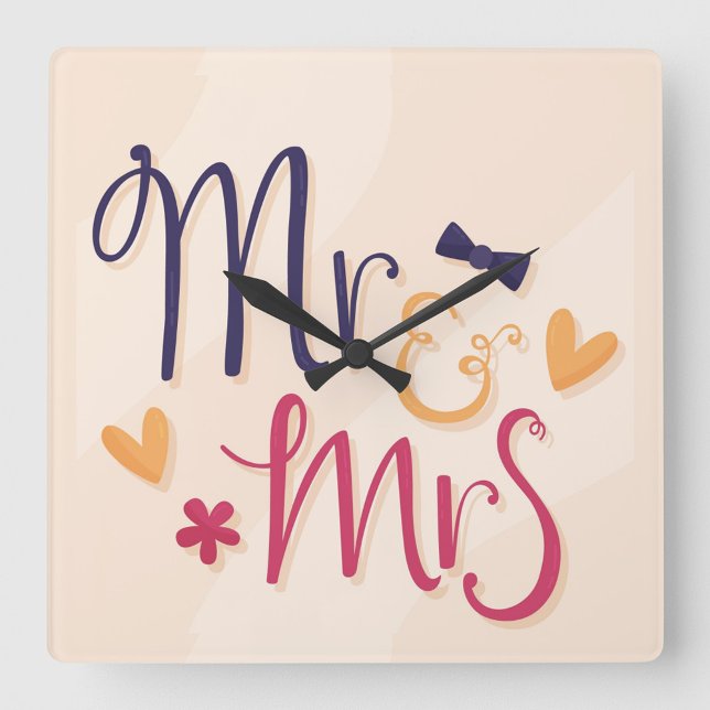 Mr och Mrs. Acrylic Wall Clock Fyrkantig Klocka (Square wall clock with the words "Mr. & Mrs" in a playful, cartoonish font.)